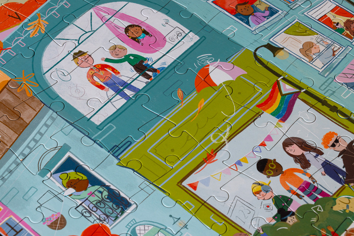 A section of a completed puzzle depicting a colorful, busy outdoor urban scene with various kids engaged in different activities around buildings.
